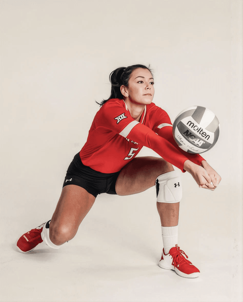 Volleyball player digging the ball low to the floor